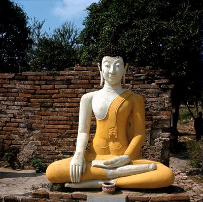 A statue of Buddha outside the temple by Thai Thai
