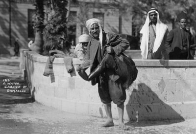 A water carrier in Damascus, Syria by Unbekannt