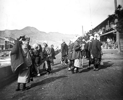 Woman Carrying Loads of Coal, Nagasaki, Japan by Unbekannt