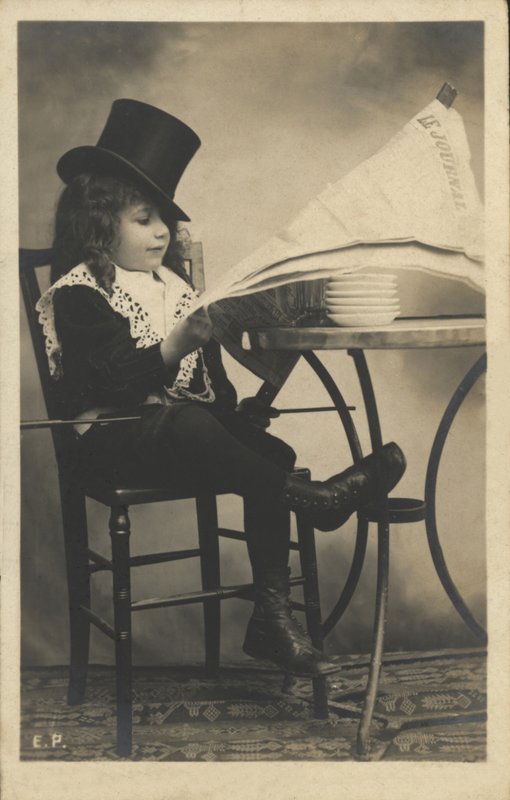 Boy Reading a Newspaper by French Photographer