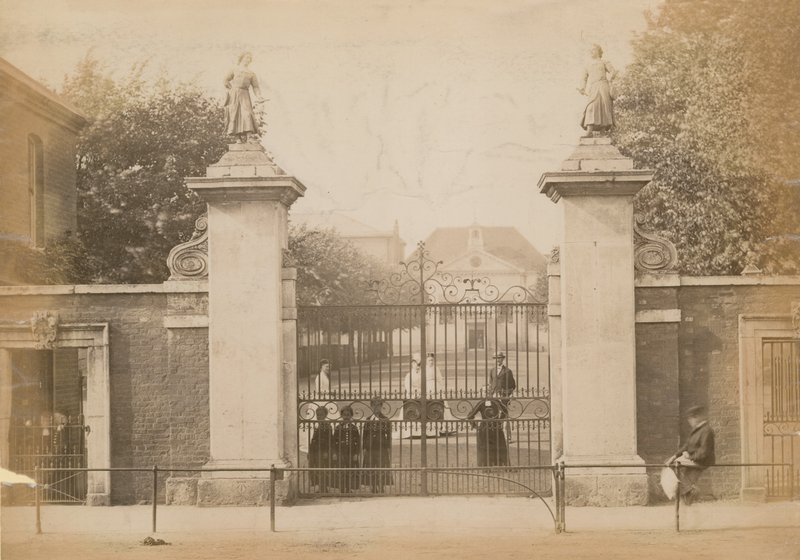 Children Standing Looking Through the School Gate by English Photographer