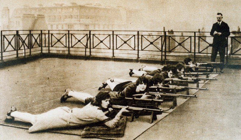 Women learning to shoot by English Photographer