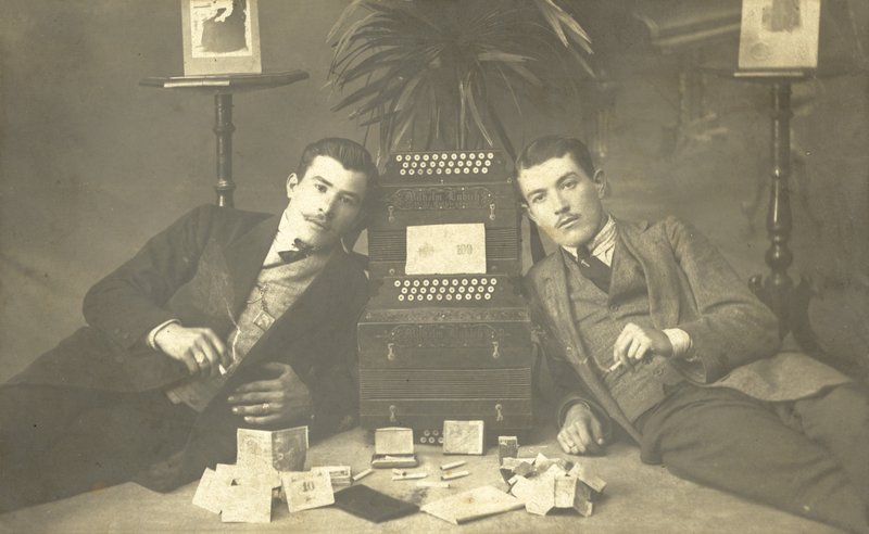 Two Men Smoking Cigarettes by Photographer German